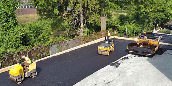 Image of Asphalt patching work being done