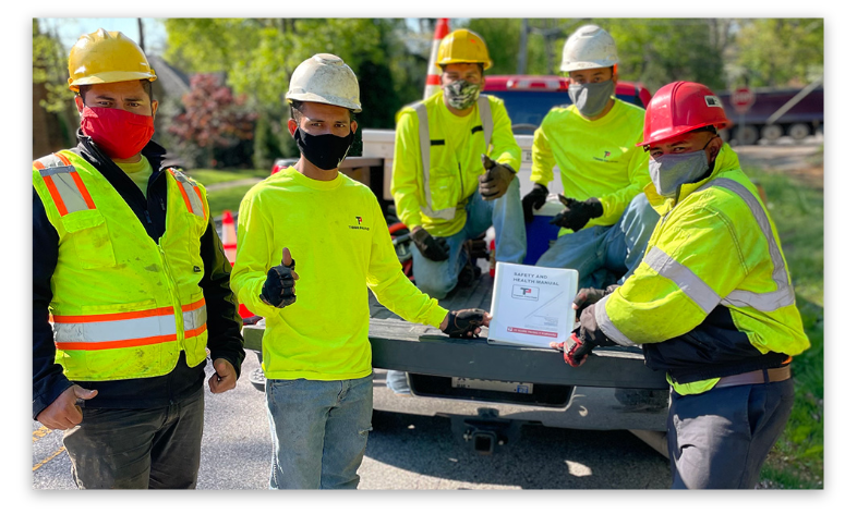 Image of Tibbs Paving workers holding plaque