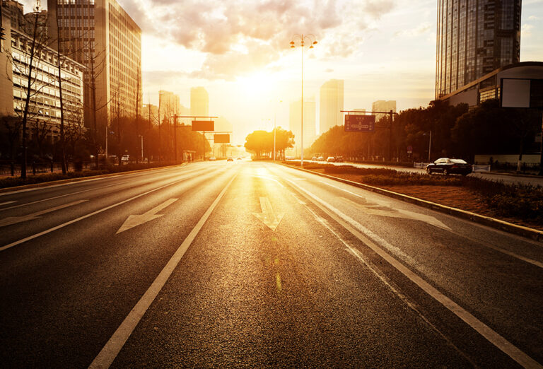 Paved road with city in the background