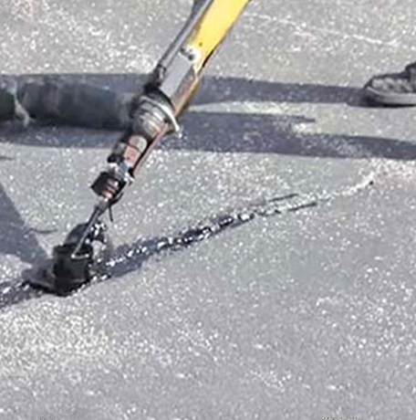 Image of crack sealing equipment on an asphalt paved road.